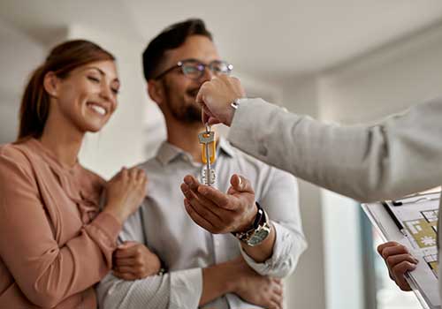 couple collecting keys from real estate agent in Trinidad & Tobago